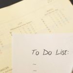 Close-up of a calendar and to-do list on a desk, emphasizing planning and organization.