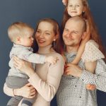 A joyful family portrait showcasing parents and their two children, expressing love and togetherness.